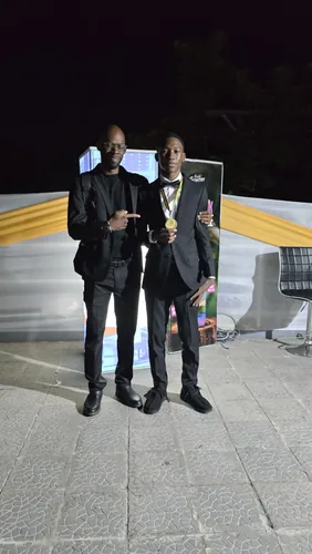 Master Kenroy Clarke with a WTM medallist at the RJR Gleaner National Sports Awards